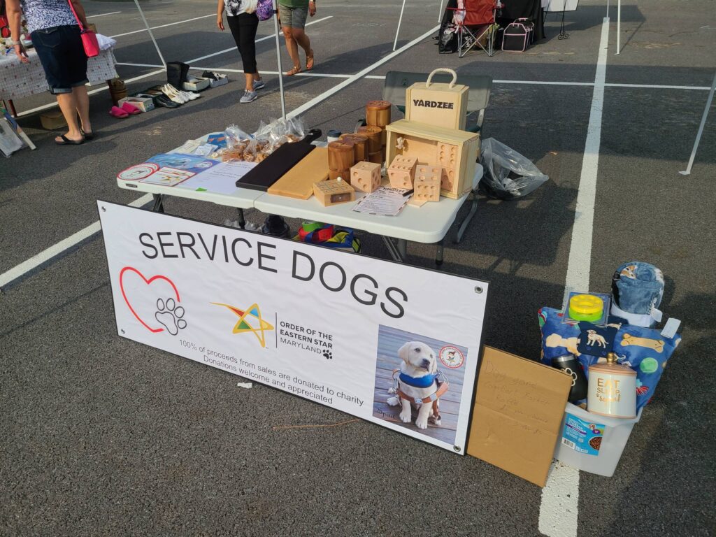 Table with handcrafted items and dog toys to support service dogs